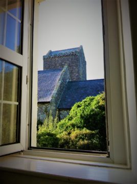 View of the church from the bedroom at Plum Cottage Llangennith self-catering