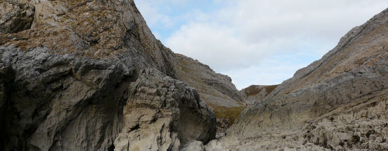 Paviland Cave (Goat's Hole) to the left of the valley