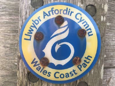 Walking in Gower: a Wales Coast Path marker